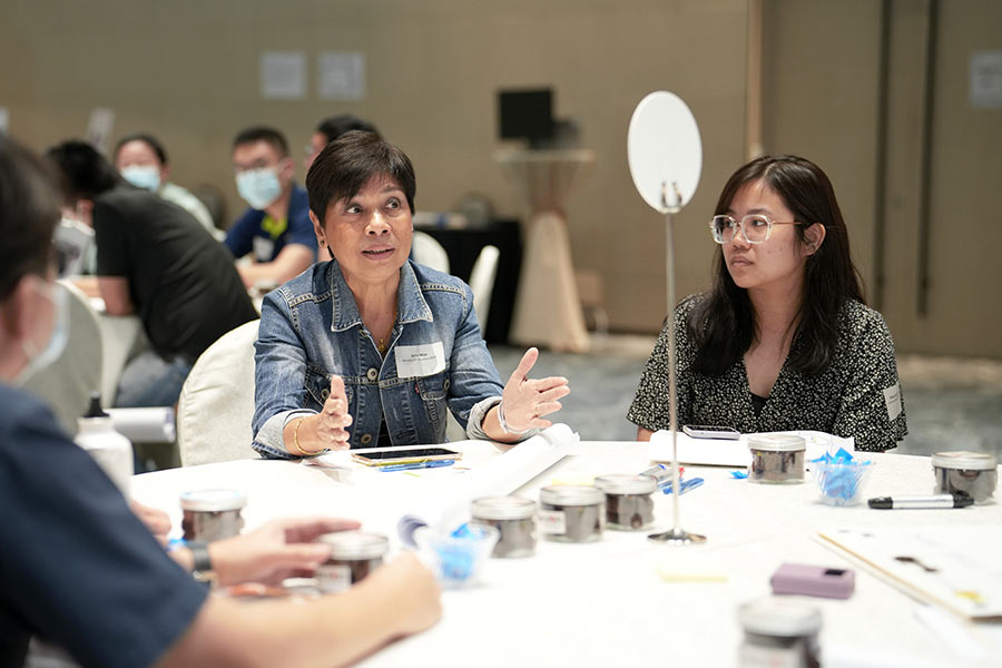 A participant sharing her views on how the Government and community partners can work together to better support the less privileged individuals within the community during the breakout group discussion at the event. (Credit: MCI / Ding Wei)