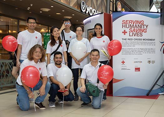 Augustine  volunteers tirelessly  in other areas with  the Singapore Red  Cross